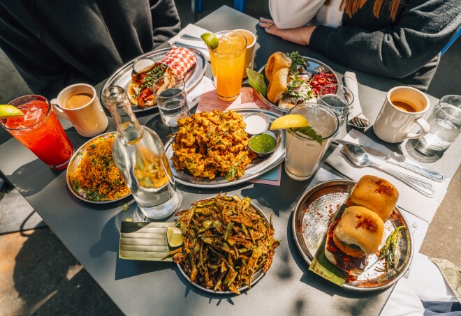 A table filled with plates of food at Chai Pani in Asheville